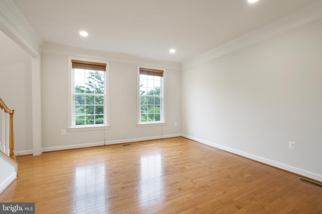 unfurnished room featuring crown molding, stairway, light wood-type flooring, baseboards, and recessed lighting