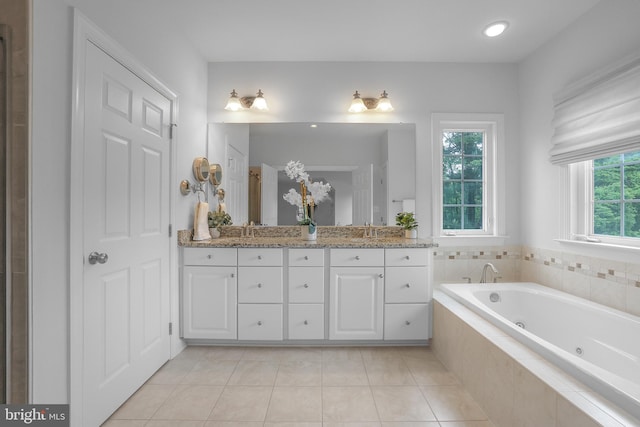 full bathroom with a jetted tub, double vanity, tile patterned floors, and recessed lighting