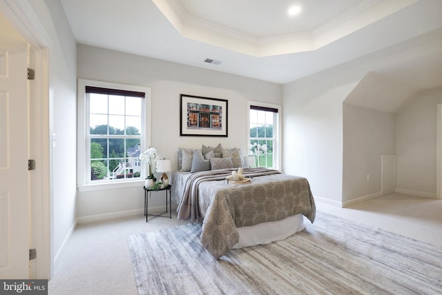 bedroom featuring carpet flooring, a tray ceiling, multiple windows, baseboards, and crown molding