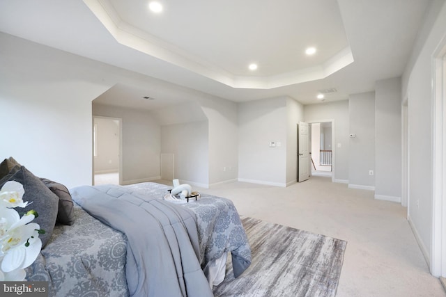 bedroom with a tray ceiling, recessed lighting, light carpet, baseboards, and crown molding