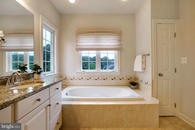 full bathroom featuring plenty of natural light, tile patterned floors, a bath, vanity, and recessed lighting