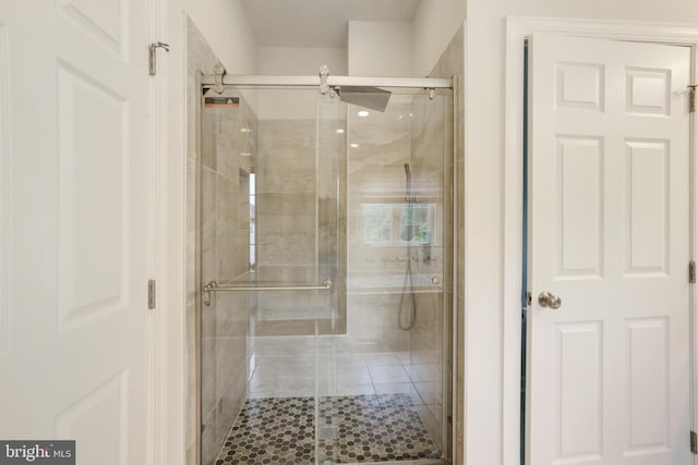 full bathroom featuring a stall shower and tile patterned floors
