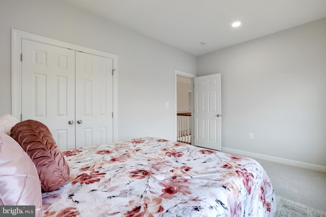 bedroom featuring a closet, carpet flooring, and baseboards
