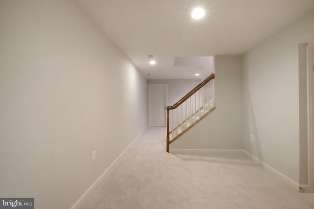 below grade area with carpet flooring, recessed lighting, baseboards, and stairs