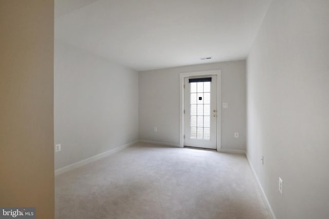 carpeted empty room featuring baseboards