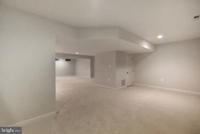 finished basement with recessed lighting, baseboards, and light carpet
