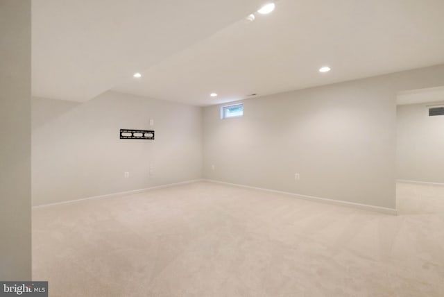 basement featuring recessed lighting, light colored carpet, and baseboards