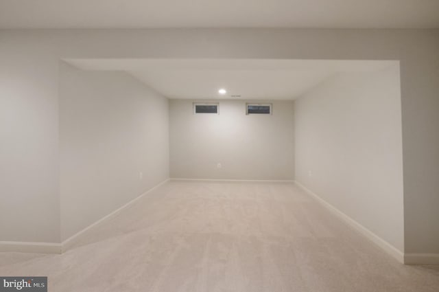 finished basement with light colored carpet, recessed lighting, and baseboards