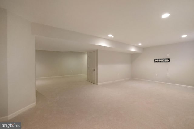 finished basement with recessed lighting, light colored carpet, and baseboards