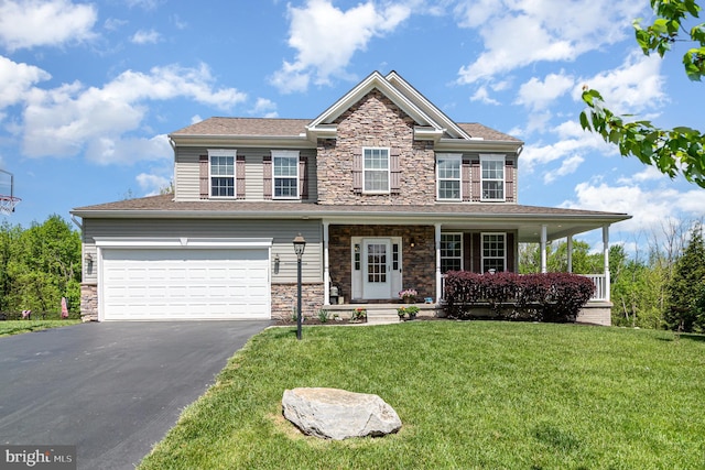 view of front of house featuring stone siding, asphalt driveway, a front yard, and a garage