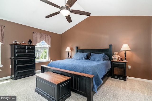 bedroom with light carpet, vaulted ceiling, baseboards, and ceiling fan