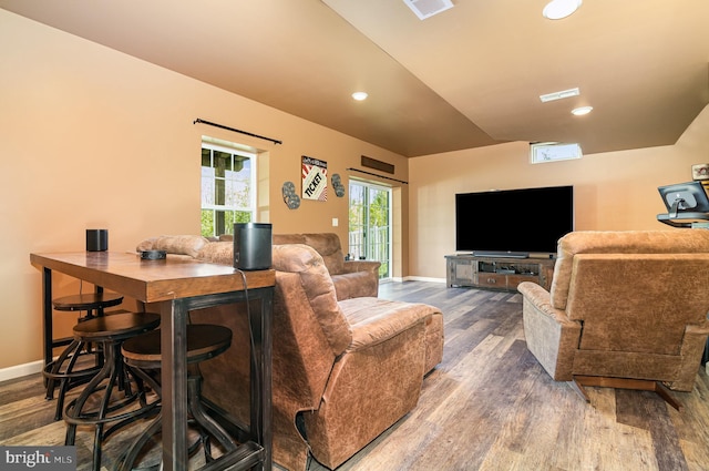 living area featuring wood finished floors, baseboards, and recessed lighting