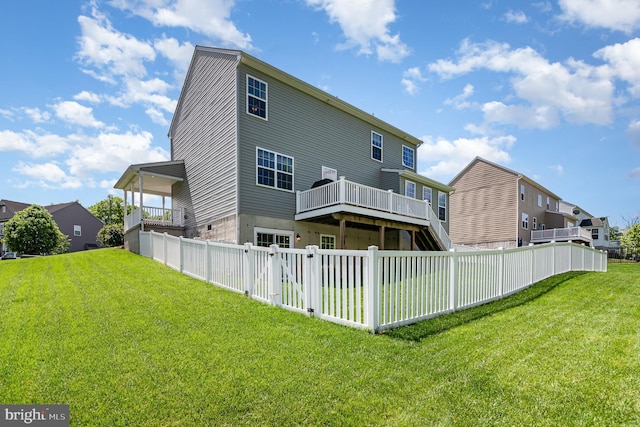 rear view of house featuring a wooden deck