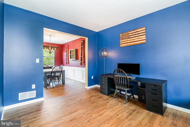 office featuring a chandelier, wood finished floors, and baseboards