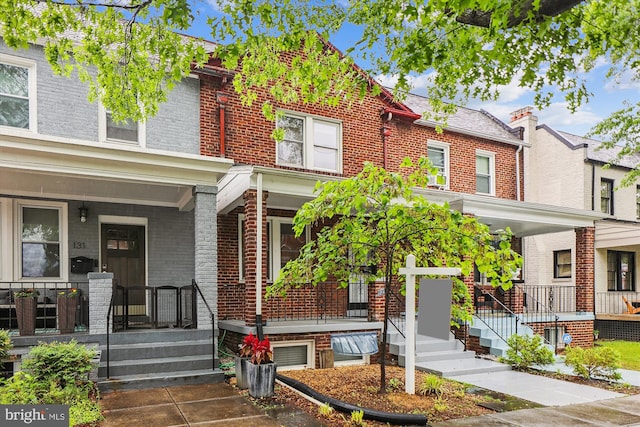 view of front of property with covered porch and brick siding