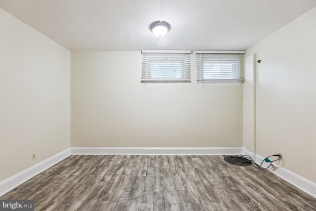 empty room with wood finished floors and baseboards