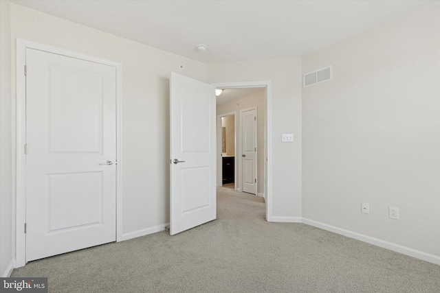 unfurnished bedroom featuring carpet floors and baseboards