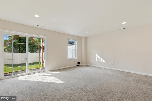 spare room featuring carpet floors, baseboards, and recessed lighting