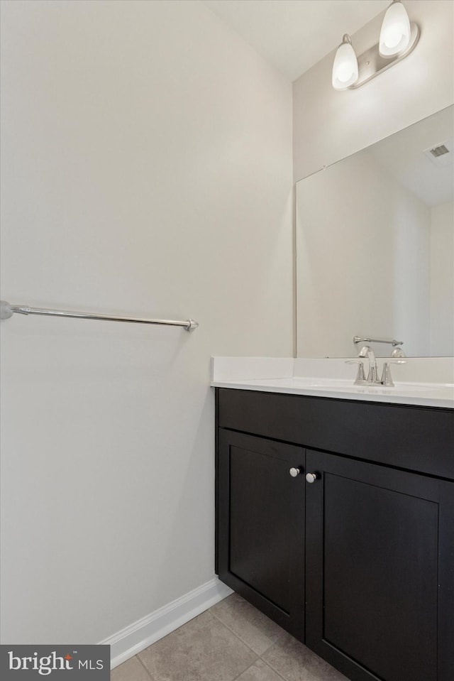 bathroom featuring tile patterned floors, vanity, and baseboards