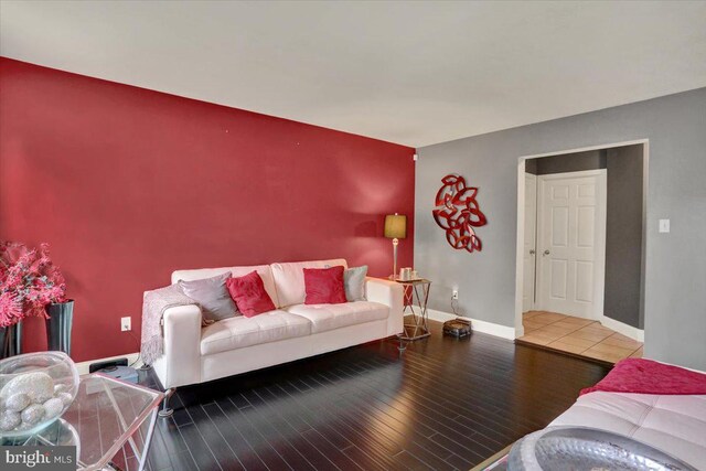 3202 Nash Rd, Reading, PA 19608 - living room with wood finished floors, baseboards, and an accent wall