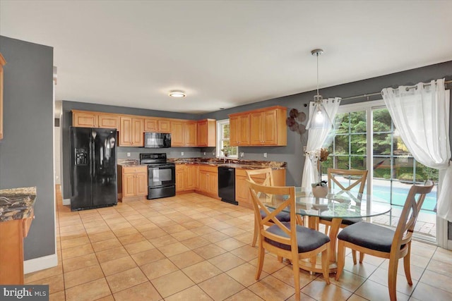3202 Nash Rd, Reading, PA 19608 - kitchen featuring black appliances, light tile patterned floors, hanging light fixtures, light brown cabinets, and baseboards