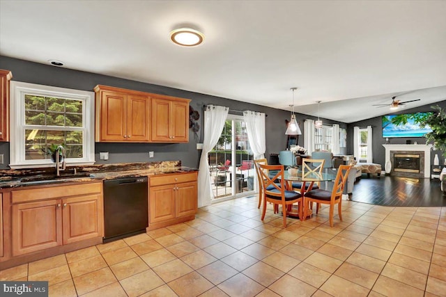 3202 Nash Rd, Reading, PA 19608 - kitchen featuring black dishwasher, a sink, a glass covered fireplace, open floor plan, and light tile patterned floors