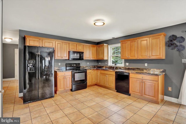3202 Nash Rd, Reading, PA 19608 - kitchen with black appliances, dark stone countertops, light tile patterned flooring, and baseboards