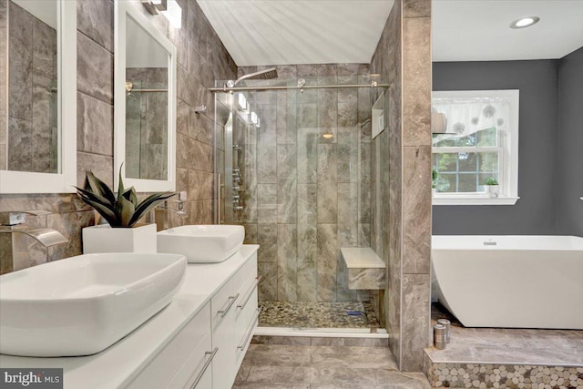 3202 Nash Rd, Reading, PA 19608 - bathroom featuring a stall shower, a freestanding bath, double vanity, marble finish flooring, and tile walls