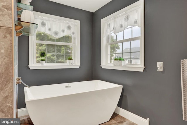 3202 Nash Rd, Reading, PA 19608 - bathroom with baseboards, plenty of natural light, and a soaking tub