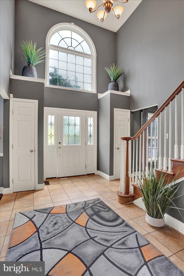 3202 Nash Rd, Reading, PA 19608 - tiled entryway featuring a high ceiling, stairs, a chandelier, and baseboards