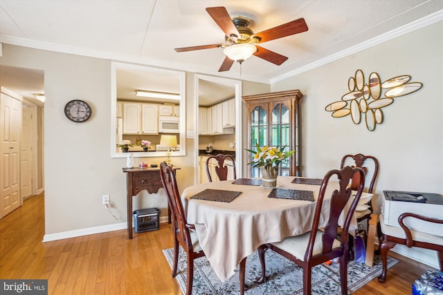 6300 Stevenson Ave Unit 523, Alexandria, VA 22304 - dining space featuring ornamental molding, a ceiling fan, light wood-style floors, and baseboards