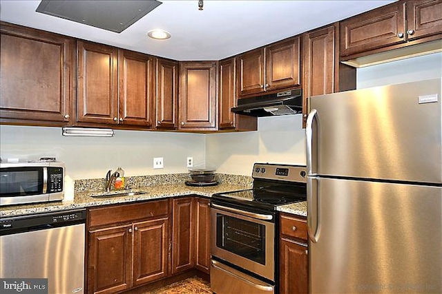 6300 Stevenson Ave Unit 523, Alexandria, VA 22304 - kitchen featuring stainless steel appliances, under cabinet range hood, a sink, light stone counters, and recessed lighting