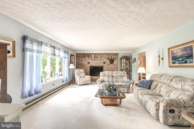 carpeted living area with baseboard heating, a stone fireplace, and a textured ceiling