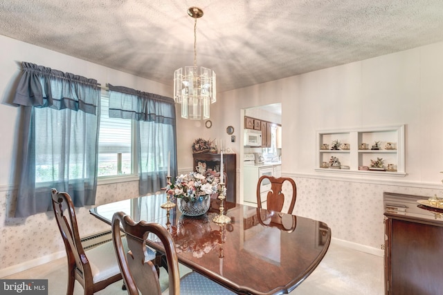 dining area featuring washer / clothes dryer, wallpapered walls, a chandelier, and a textured ceiling