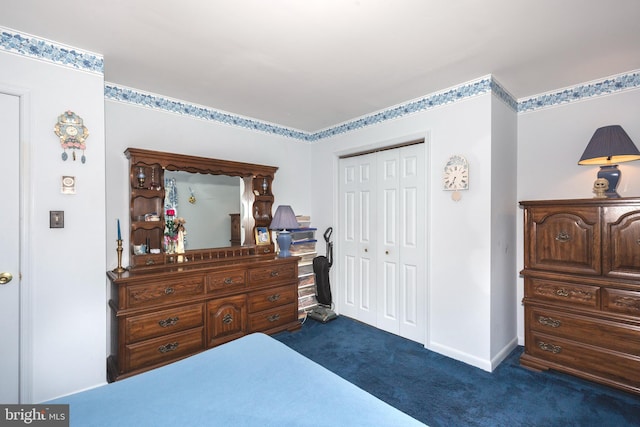 bedroom with dark carpet, a closet, and baseboards