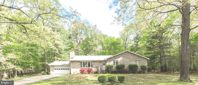 ranch-style house featuring a chimney, brick siding, driveway, a front lawn, and an attached garage