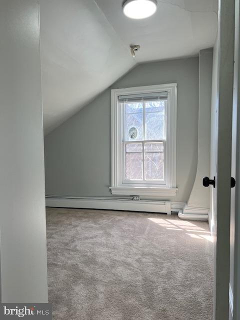 bonus room with lofted ceiling, carpet flooring, and a baseboard heating unit