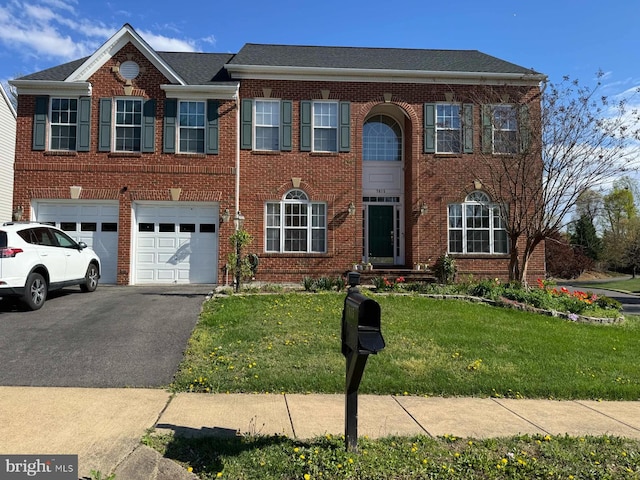 7615 Mcweadon Ln, Springfield, VA 22150 - georgian-style home with driveway, brick siding, a garage, and a front yard