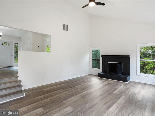 143 Zinn Way, Linden, VA 22642 - unfurnished living room featuring high vaulted ceiling, wood finished floors, ceiling fan, stairway, and a fireplace with raised hearth