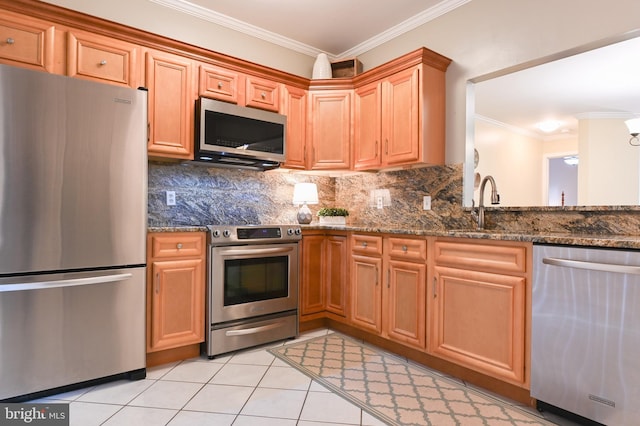 2012 Quay Village Ct Unit 202, Annapolis, MD 21403 - kitchen featuring stainless steel appliances, ornamental molding, backsplash, dark stone counters, and light tile patterned floors