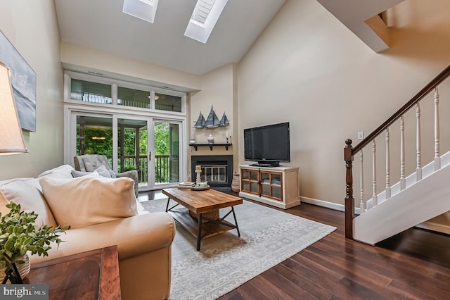 2012 Quay Village Ct Unit 202, Annapolis, MD 21403 - living room featuring a high ceiling, wood finished floors, stairway, baseboards, and a skylight