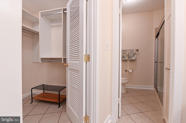 2012 Quay Village Ct Unit 202, Annapolis, MD 21403 - bathroom featuring tile patterned floors, toilet, a stall shower, and baseboards