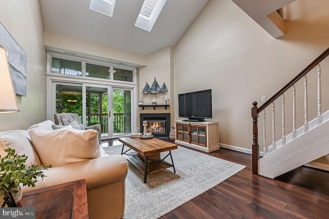 2012 Quay Village Ct Unit 202, Annapolis, MD 21403 - living area with high vaulted ceiling, dark wood-style floors, stairs, a skylight, and baseboards