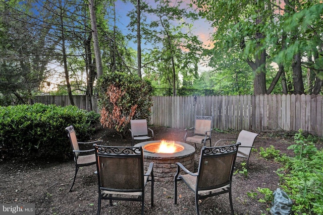 1716 Olmsted Way E, Camp Hill, PA 17011 - patio terrace at dusk with an outdoor fire pit and a fenced backyard