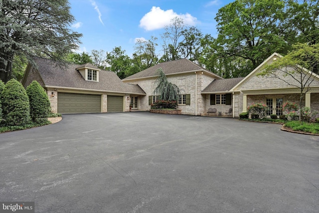 1716 Olmsted Way E, Camp Hill, PA 17011 - view of front of home featuring a garage, driveway, roof with shingles, french doors, and stone siding