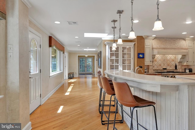1716 Olmsted Way E, Camp Hill, PA 17011 - kitchen featuring light wood-type flooring, light countertops, tasteful backsplash, a kitchen breakfast bar, and recessed lighting