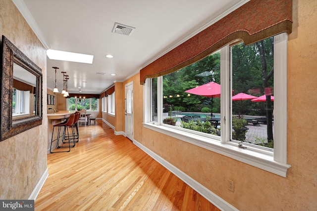 1716 Olmsted Way E, Camp Hill, PA 17011 - hallway with wood finished floors, crown molding, baseboards, a chandelier, and a skylight