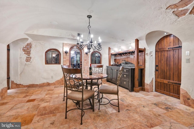 1716 Olmsted Way E, Camp Hill, PA 17011 - dining area with arched walkways, light stone finish flooring, a chandelier, and lofted ceiling