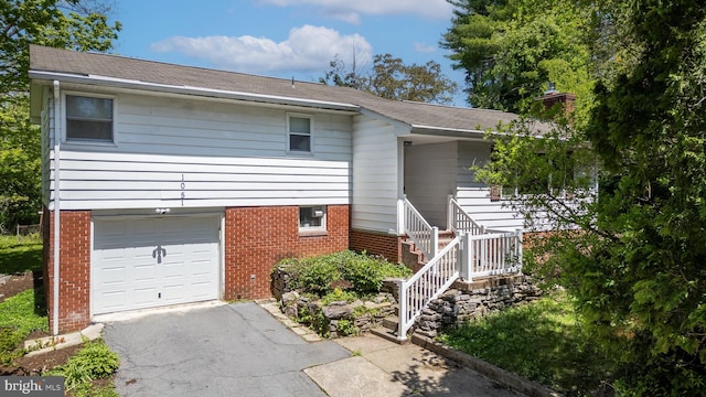 1051 Taylor St, State College, PA 16803 - view of front of home with brick siding, a garage, and asphalt driveway