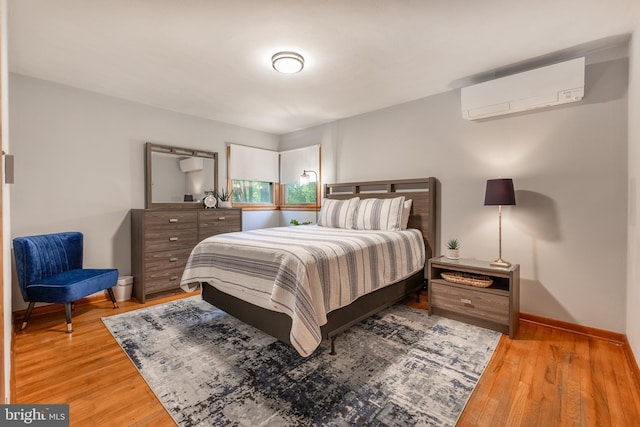 1051 Taylor St, State College, PA 16803 - bedroom featuring an AC wall unit, wood finished floors, and baseboards